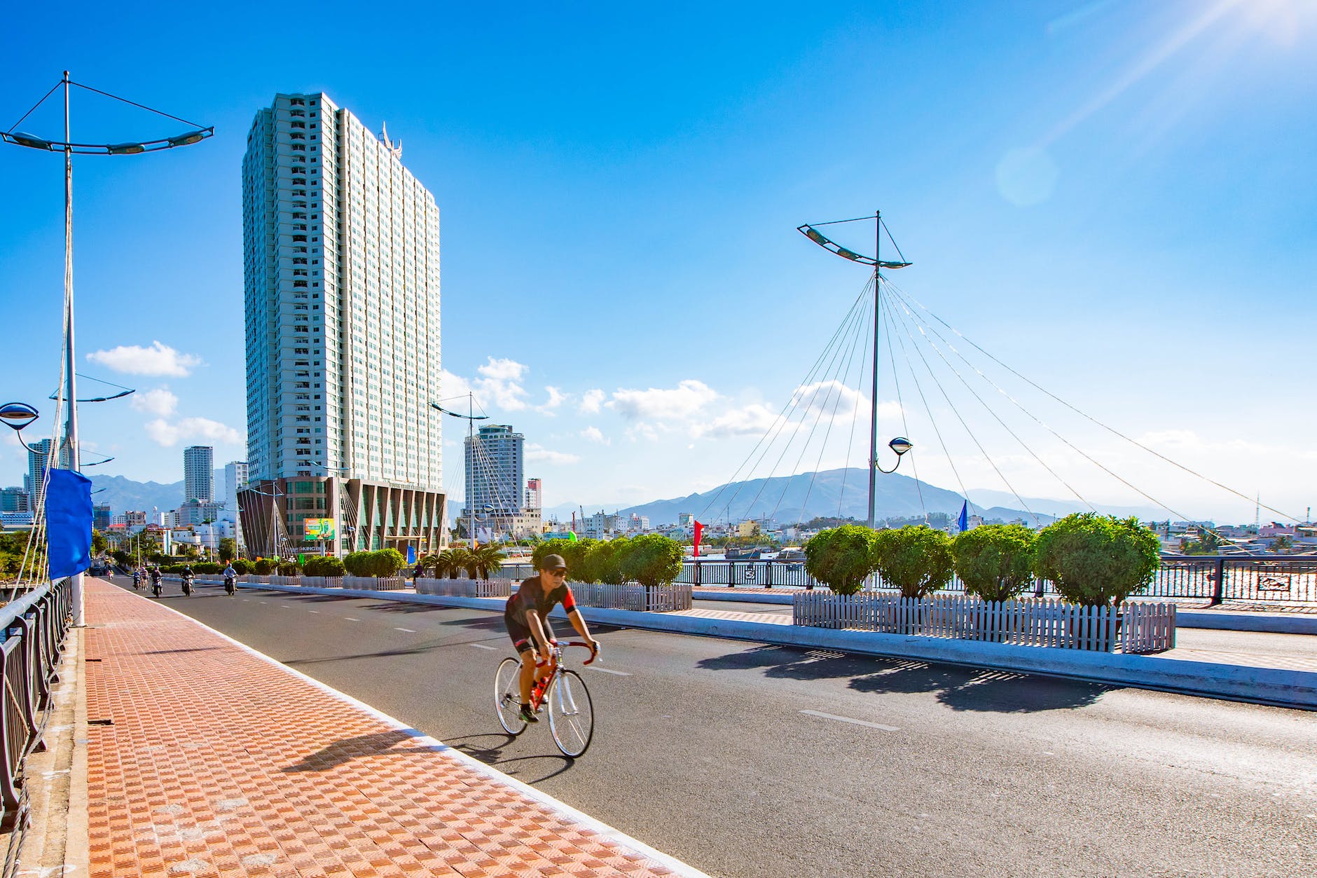 man in black shirt riding bicycle on road